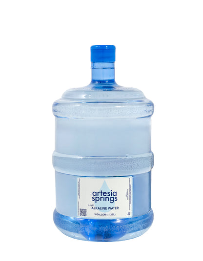 Large water bottle with blue cap and Artesia Springs label on a white background